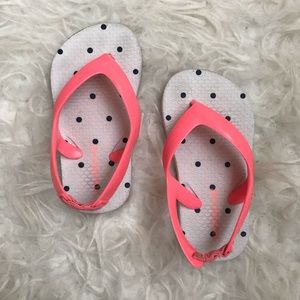 Pink and navy polka dot flip flops